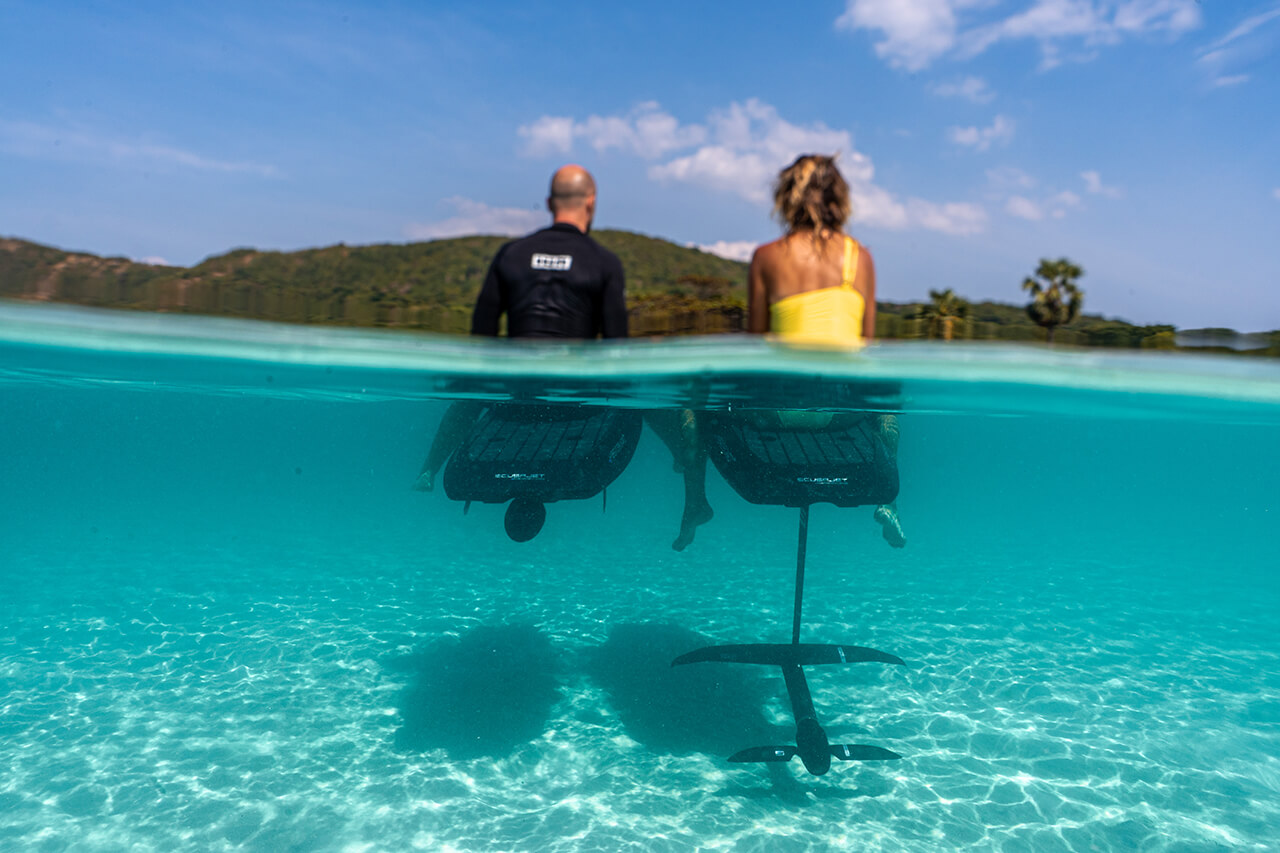 Woman e-surfing on the SCUBAJET Performance E-Surf Board